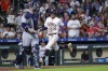 Houston Astros' Mauricio Dubon (14) scores behind Cleveland Guardians catcher David Fry, left, on the RBI single by Jose Altuve during the sixth inning of a baseball game Wednesday, May 1, 2024, in Houston. (AP Photo/Michael Wyke)