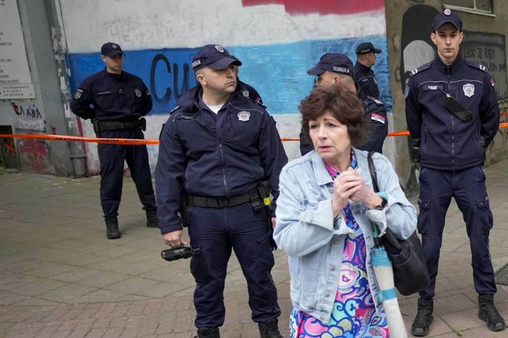 FILE - Police block streets around the Vladislav Ribnikar school in Belgrade, Serbia, Wednesday, May 3, 2023. A teenage boy opened fire at the school on the morning of May 3, 2023. Eight children and a school guard died, and seven people were wounded. One of the wounded, a child, died from injuries later. A total of 10 people were killed. (AP Photo/Darko Vojinovic, File)