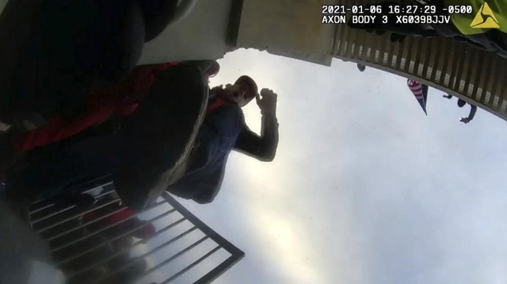 This image from police body-worn camera video, contained and annotated in the Justice Department's sentencing memorandum for Jack Wade Whitton, shows Whitton at the U.S. Capitol on Jan. 6, 2021, in Washington. Whitton, a Georgia business owner, has been sentenced to nearly five years in prison for striking an officer with a metal crutch and dragging him, head first and face down, into the crowd on the Capitol’s Lower West Terrace during the riot at the Capitol. (Department of Justice via AP)