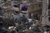 FILE - Palestinians look at the destruction after an Israeli strike on residential buildings and a mosque in Rafah, Gaza Strip, Feb. 22, 2024. Israel and Hamas appear to be seriously negotiating an end to the war in Gaza and the return of Israeli hostages. A leaked truce proposal hints at concessions by both sides following months of stalemated talks. (AP Photo/Fatima Shbair, File)