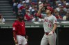 Cleveland Guardians' Bo Naylo, left, looks on as Los Angeles Angels' Nolan Schanuel (18) gestures after hitting a solo home run off Guardians starting pitcher Tanner Bibee during the third inning of a baseball game in Cleveland, Friday, May 3, 2024. (AP Photo/Phil Long)