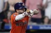 Houston Astros' Jose Altuve hits an RBI bunt single during the seventh inning of a baseball game against the Seattle Mariners Friday, May 3, 2024, in Houston. (AP Photo/Kevin M. Cox)