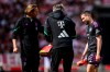Munich's Raphael Guerreiro, right, leaves the pitch injured, during the German Bundesliga soccer match between Bayern Munich and VfB Stuttgart, in Stuttgart, Germany, Saturday, May 4, 2024. (Tom Weller/dpa via AP)