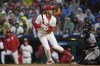 Philadelphia Phillies' Alec Bohm is hit by a pitch from San Francisco Giants' Keaton Winn with the bases loaded to score a run during the first inning of a baseball game, Saturday, May 4, 2024, in Philadelphia. (AP Photo/Matt Slocum)