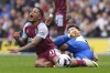 Aston Villa's Leon Bailey, left, is tackled by Brighton and Hove Albion's Billy Gilmour during the Premier League match between Brighton & Hove Albion and Aston Villa, at the American Express Stadium in Brighton, England, Sunday May 5, 2024. (Gareth Fuller/PA via AP)