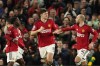 Manchester United's Harry Maguire, centre, celebrates with his teammates after scoring his side's opening goal during the English Premier League soccer match between Manchester United and Sheffield at the Old Trafford Stadium in Manchester, England, Wednesday, April 24, 2024. (AP Photo/Dave Thompson)