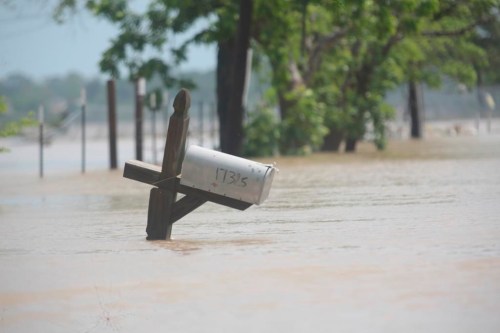 A mailbox is partially submerged on a flooded street in an unincorporated area in east Harris County near Houston on Sunday morning, May 5, 2024. The nearby San Jacinto River, overflowing due to heavy rainfall earlier this week, caused the flood waters. (AP Photo/Lekan Oyekanmi)