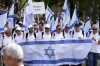People carry Israel's flags as they march through the former Nazi German death camp of Auschwitz-Birkenau during the annual Holocaust remembrance event, the 