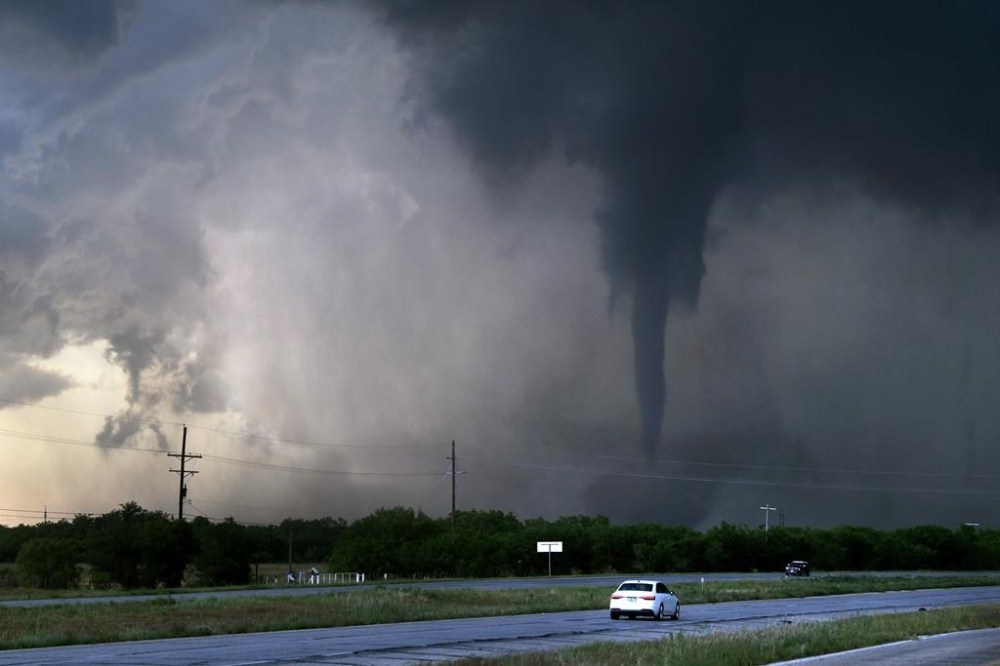 A tornado spins west of Hawley, Texas, as cars pass on U.S. 277 on Thursday May 2, 2024. (Ronald W. Erdrich/The Abilene Reporter-News via AP)
