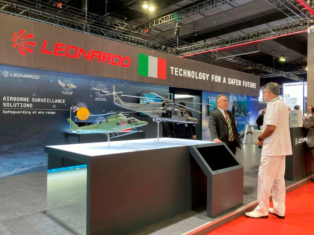Malaysian military personnel stand at the booth of Leonardo, a company that specializes in aerospace, defense, and security, at the Defense Services Asia (DSA) exhibition in Kuala Lumpur, Malaysia Tuesday, May 7, 2024. (AP Photo/Syawalludin Zain)