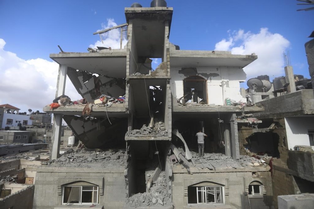 Palestinians look at the destruction after an Israeli strike on residential building in Rafah, Gaza Strip, Tuesday, May 7, 2024. (AP Photo/Ismael Abu Dayyah)