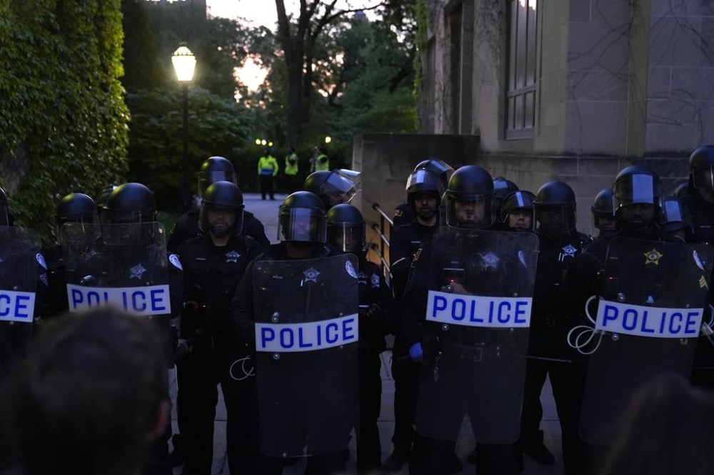 Police block pro-Palestinian protesters from returning to their encampment as the encampment is dismantled at the University of Chicago, Tuesday, May 7, 2024. (AP Photo/Charles Rex Arbogast)