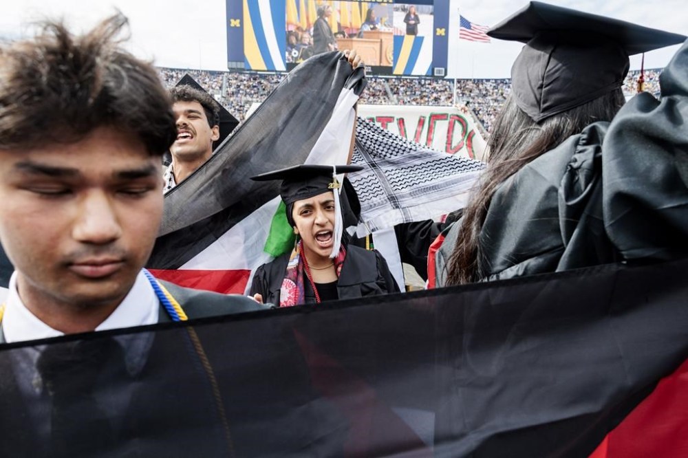 FILE - Pro-Palestinian protesters demonstrate during the University of Michigan's Spring 2024 Commencement Ceremony at Michigan Stadium in Ann Arbor, Mich., May 4, 2024. As pro-Palestinian protests escalate on college campuses around the country, critics of President Joe Biden’s handling of the Israel-Hamas war suggest this summer’s Democratic National Convention could be marred by protests and scenes of chaos that undermine his reelection. It raises the specter of a replay of 1968’s Democratic convention in Chicago, where a violent police crackdown created indelible scenes of chaos. (Jacob Hamilton/Ann Arbor News via AP, file)