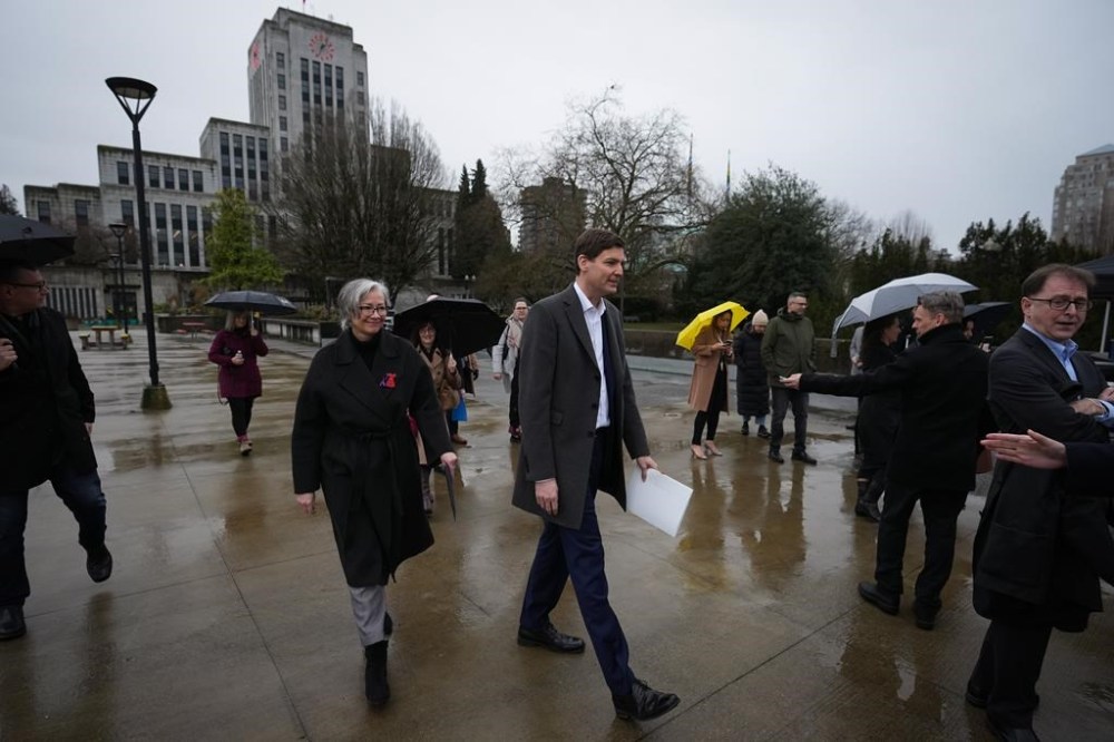 The BC Coroners Service says the relentless toll of the overdose crisis, which has killed another 192 people this past March, makes it the leading cause of death for those aged between 10 and 59, surpassing accidents, suicide, homicides and natural causes combined. B.C. Premier David Eby, centre, and B.C. Minister of Mental Health and Addictions Jennifer Whiteside, left, arrive for a news conference in Vancouver, B.C., Sunday, Feb. 5, 2023. THE CANADIAN PRESS/Darryl Dyck