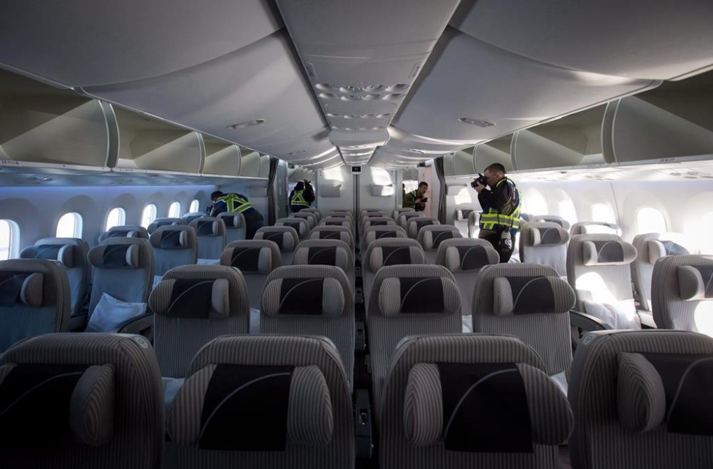 An airplane travelling from Paris to Seattle was forced to make an emergency landing at Iqaluit’s airport. Members of the media take photos and record video in the forward economy cabin of a Boeing 787-800 Dreamliner after it arrived at Vancouver International Airport in Richmond, B.C., Monday, Feb. 3, 2014. THE CANADIAN PRESS/Darryl Dyck
