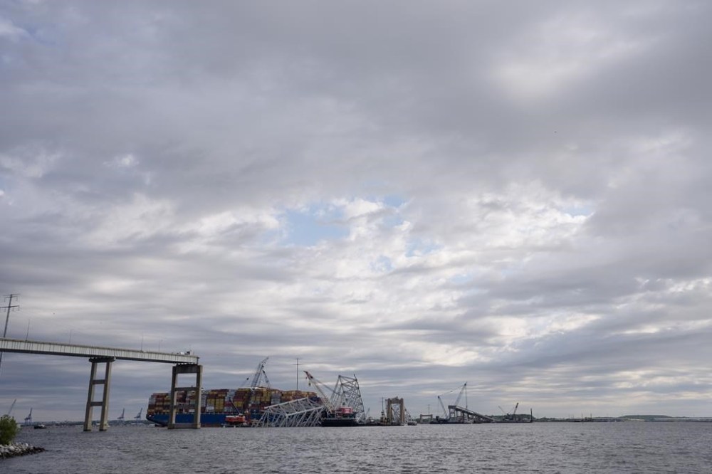 The collapsed Francis Scott Key Bridge lays on top of the container ship Dali, Thursday, April 25, 2024, in Baltimore. (AP Photo/Matt Rourke)