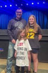 Mike Dean and his two daughters – one wearing a shirt that says 