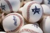 FILE - Baseballs sit in a basket during the baseball draft combine June 20, 2023, in Phoenix. Major League Baseball has warned its teams against encouraging players to withdraw from high school baseball to avoid the amateur draft and pursue the increased flexibility of international free agency. The memo was sent to front offices Monday, May 6, by John D’Angelo, Major League Baseball’s vice president of amateur and medical baseball operations. (AP Photo/Matt York, File)