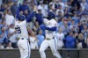 Kansas City Royals' Kyle Isbel (28) and Bobby Witt Jr. celebrate after scoring on a two-run double by Vinnie Pasquantino during the fifth inning of a baseball game against the Milwaukee Brewers Tuesday, May 7, 2024, in Kansas City, Mo. (AP Photo/Charlie Riedel)