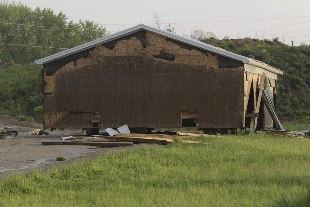 Debris litters the ground near a damaged building after a tornado swept through the area of the Pavilion Estates mobile home park, in Kalamazoo, Mich., Tuesday, May 7, 2024. ( J. Scott Park/Jackson Citizen Patriot via AP)