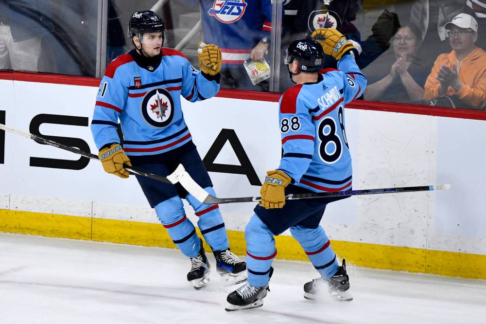Fred Greenslade / THE CANADIAN PRESS
Cole Perfetti (left) celebrates with Nate Schmidt Tuesday after scoring the go-ahead goal against the L.A. Kings.