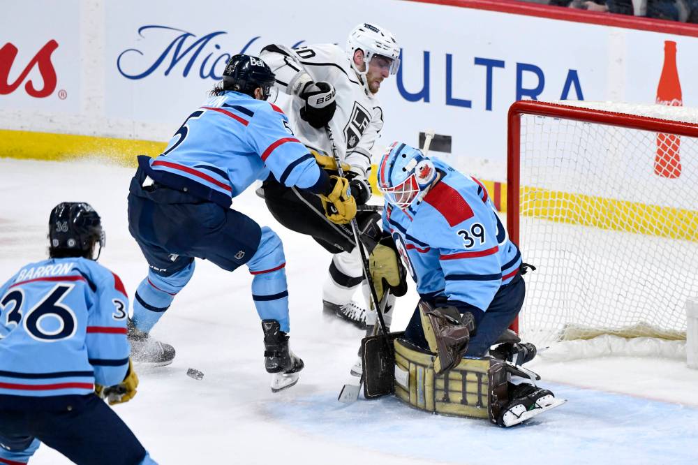 Fred Greenslade / THE CANADIAN PRESS
Jets goaltender Laurent Brossoit stops Kings forward Pierre-Luc Dubois Tuesday night with some help from Brenden Dillon.