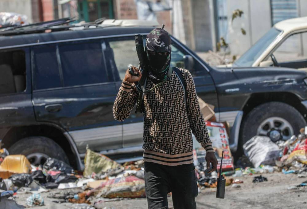 The Associated Press
An armed member of the G9 and Family gang patrols a roadblock in the Delmas 6 neighborhood of Port-au-Prince, Haiti, in March, 2024.