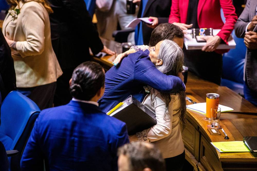 MIKAELA MACKENZIE / FREE PRESS
Finance Minister Adrien Sala hugs Families Minister Nahanni Fontaine on budget day Tuesday. Critics say the budget offers little to celebrate regarding climate change.