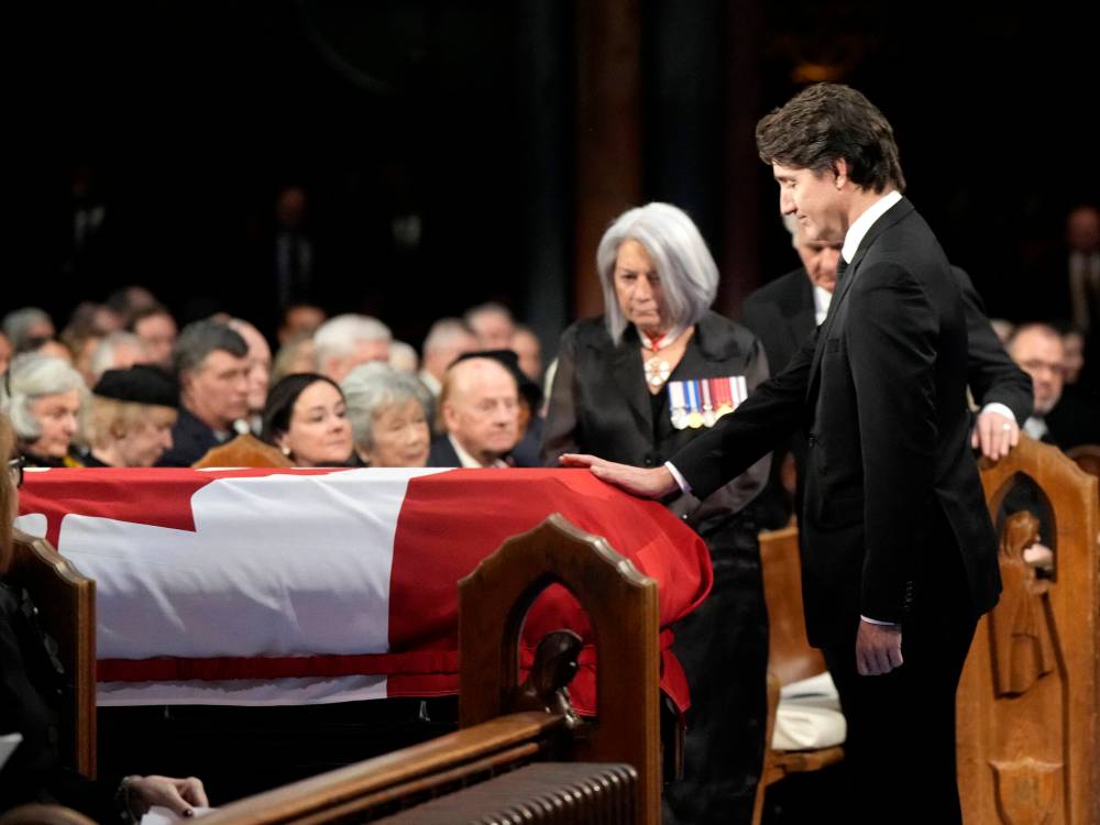 Ryan Remiorz/The Canadian Press
Prime Minister Justin Trudeau places his hand on the casket during the funeral of former prime minister Brian Mulroney, in Montreal on March 23. Trudeau, Charles Adler writes, was able to meet the moment appropriately.