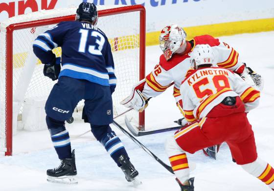 Winnipeg Jets' Gabriel Vilardi scores on Calgary Flames goaltender Dustin Wolf as Oliver Kylington defends during the first period. (John Woods / The Canadian Press)