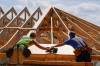 File - Carpenters work on a home on Sept. 19, 2023, in Marshall, N.C. On Monday, the Labor Department reports on job openings and labor turnover for December. (AP Photo/Chris Carlson, File)