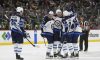 Winnipeg Jets defenceman Brenden Dillon (5) celebrates with teammates after scoring during the second period of an NHL game against the Minnesota Wild, Saturday, April 6, 2024, in St. Paul, Minn. (AP Photo/Abbie Parr)
