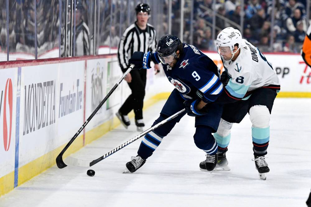 Whether it‘s killing penalties, looking for goals on the power play or anything in between, Jets forward Alex Iafallo (left) has proven he can get the job done. (Fred Greenslade / The Canadian Press files)