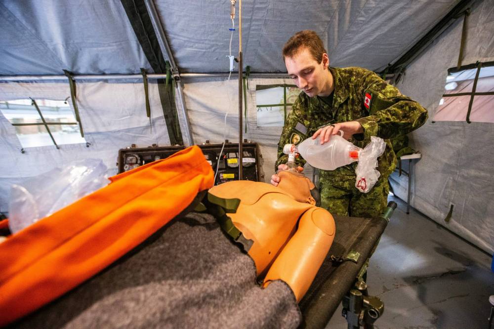 MIKAELA MACKENZIE / FREE PRESS Private George McKeever demonstrates securing an airway and helping a patient breathe in a mobile medical treatment facility.