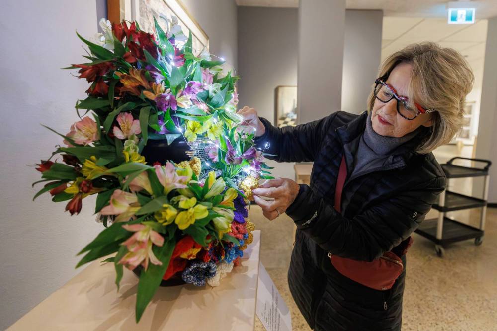WAG-Qaumajuq associate Carla Goldstein puts finishing touches on her arrangement, which interprets a Jean-Paul Riopelle work. (Mike Deal / Free Press)