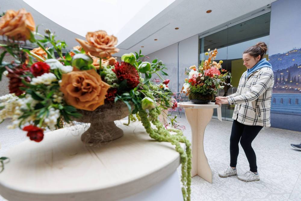 Kayla Harman from Flora Culture sets up her arrangement for Art in Bloom at WAG-Qaumajuq. (Mike Deal / Free Press)