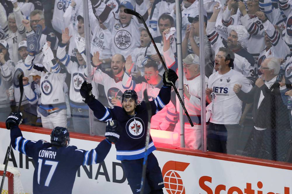 Adam Lowry (left) and Brandon Tanev celebrate after Tanev bulged the twine against the Nashville Predators in 2018 second-round playoff action in front of a boisterous crowd in Winnipeg. (John Woods / Free Press files)