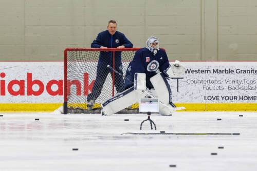 MIKE DEAL / FREE PRESS
Winnipeg Jets’ goaltender, Connor Hellebuyck (37) works out for the film with assistant coach Wade Flaherty during practice at the Hockey For All Centre Friday.