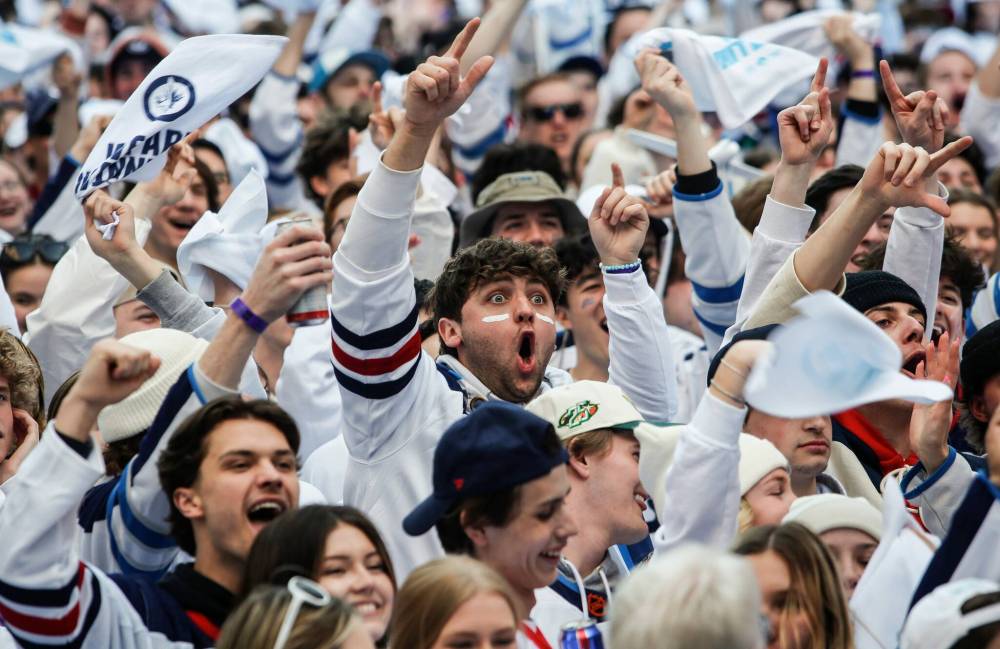 JOHN WOODS / FREE PRESS Fans at the Whiteout Street party on Donald Street on Sunday.