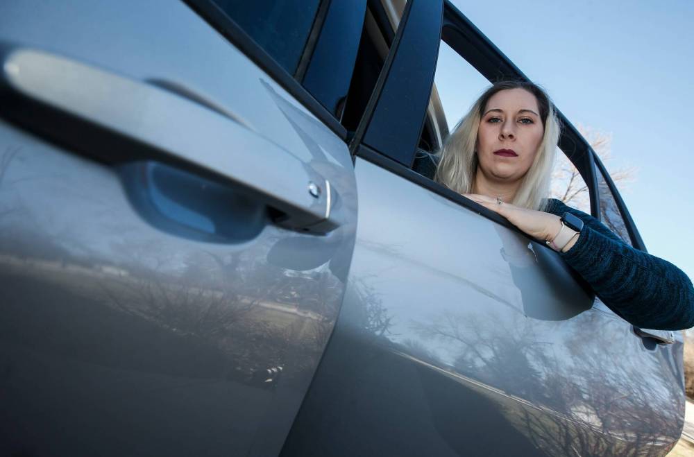 JOHN WOODS / FREE PRESS
Cassie Fotheringham checks the scratch on her vehicle after she alleges a person sideswiped
her SUV in Winnipeg Tuesday.