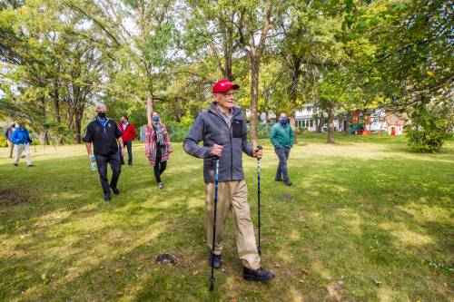 MIKAELA MACKENZIE / FREE PRESS Files
                                Douglas MacEwan walks in his Tuxedo neighbourhood with arts directors and friends on Sept. 15, 2020, as part of his daily, kilometre-long walk fundraising campaign as he neared his 96th birthday.