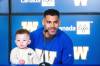 MIKAELA MACKENZIE / FREE PRESS
                                Andrew Harris, accompanied by his 18-month-old son Axton, speaks Friday at Princess Auto Stadium.