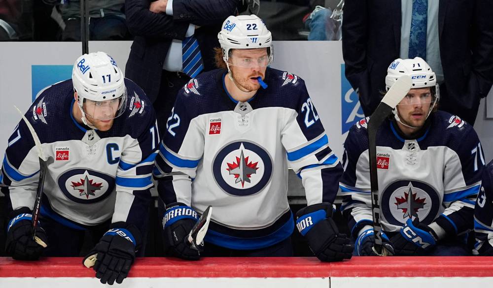 Winnipeg Jets captain Adam Lowry, left, Mason Appleton and left wing Axel Jonsson-Fjallby, look on as time runs out in the third period. (David Zalubowski / The Associated Press)