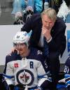 Winnipeg Jets hesd coach Rick Bowness, top, confers with center Mark Scheifele (55) in the third period of Game 4 of an NHL Stanley Cup first-round playoff series against the Colorado Avalanche, Sunday, April 28, 2024, in Denver. (David Zalubowski / The Associated Press)