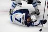 Winnipeg Jets center Vladislav Namestnikov (7) falls to the ice after taking a slap shot to the face in the third period of Game 4 of an NHL Stanley Cup first-round playoff series against the Colorado Avalanche, Sunday, April 28, 2024, in Denver. (AP Photo/David Zalubowski)