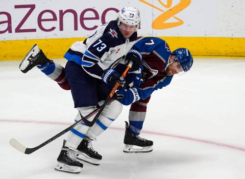 David Zalubowski / The Associated Press
                                Jets forward Tyler Toffoli checks Avalanche defenceman Devon Toews on Sunday in Denver.
