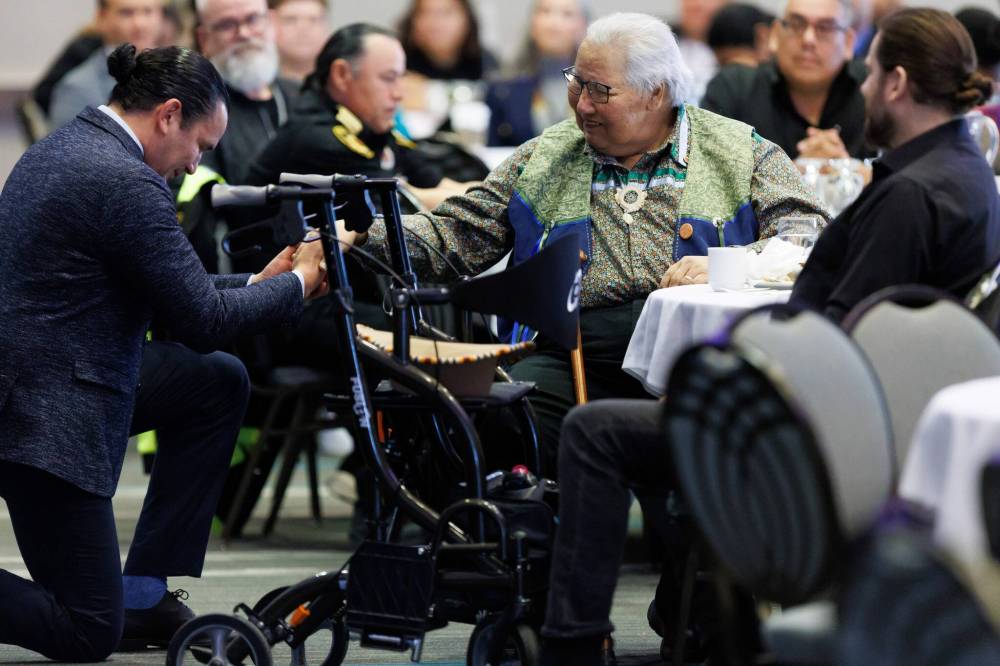 Premier Wab Kinew kept the spirits high while introducing Justice Murray Sinclair during the summit. (Mike Deal / Free Press)