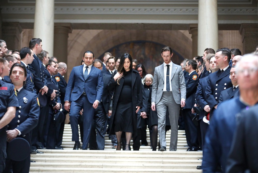 Tashakor walks down the grand staircase of the Legislative Building escorted by Premier Wab Kinew and MLA David Pankratz, along with 200 firefighters and rescue personal. (Ruth Bonneville / Free Press)