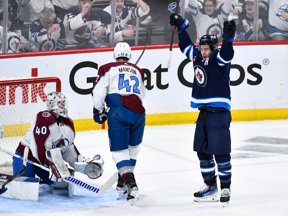 Winnipeg Jets centre Sean Monahan (23) and teammate Neal Poink (4) battle with Colorado Avalanche defenceman Sean Walker (26) and Josh Manson (42) in front of Avalanche goaltender Alexandar Georgiev during the second period. (Fred Greenslade / The Canadian Press)