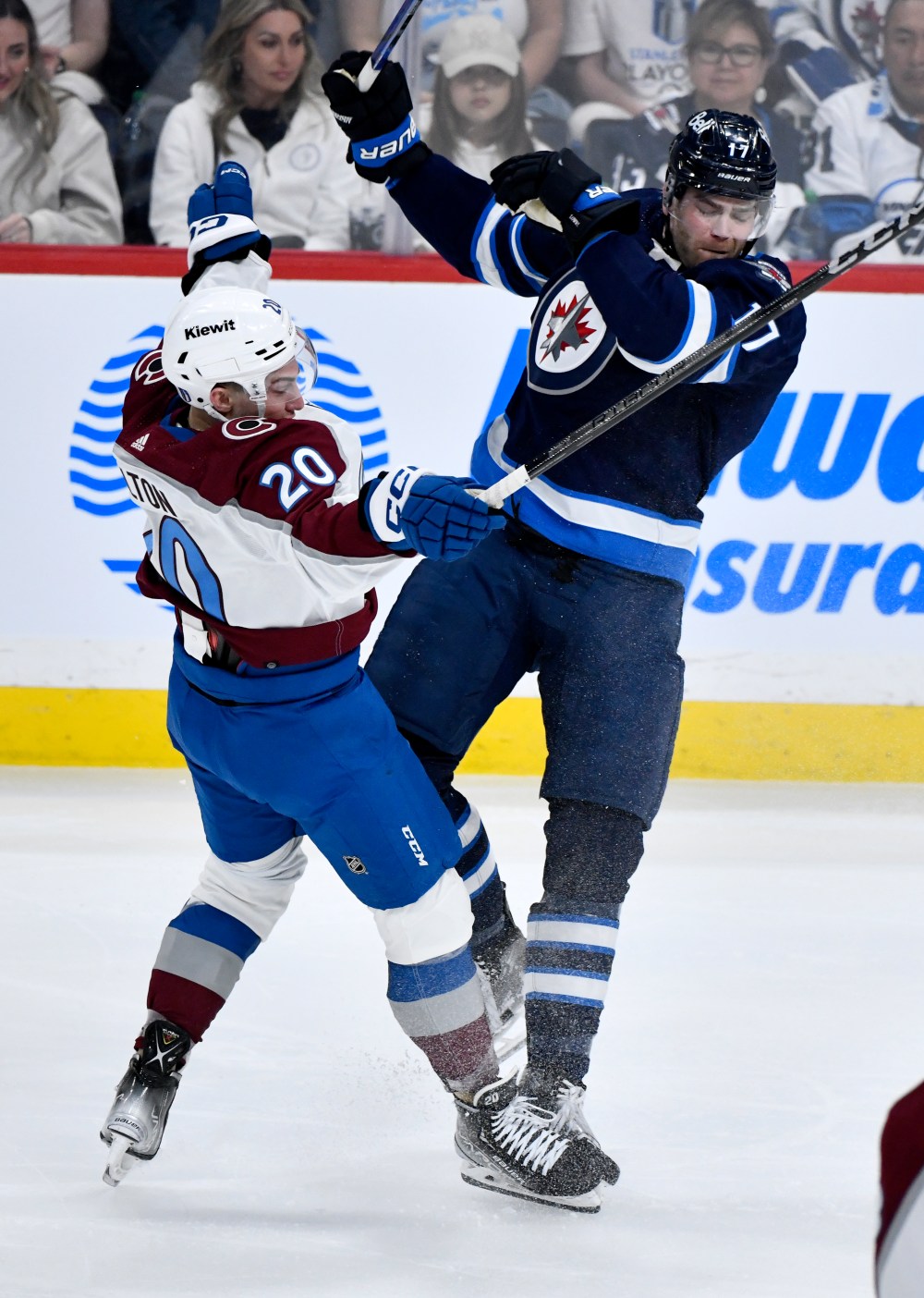 Colorado Avalanche centre Ross Colton (20) collides with Winnipeg Jets centre Adam Lowry (17) during the second period. (Fred Greenslade / The Canadian Press)
